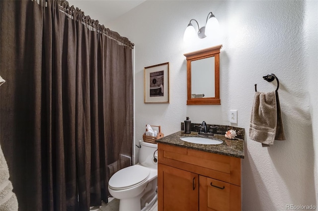 236 E Fair Ln, Centennial, CO 80121 - full bathroom with vanity, toilet, and a textured wall