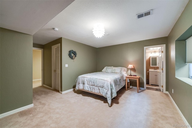236 E Fair Ln, Centennial, CO 80121 - carpeted bedroom featuring a sink, baseboards, and connected bathroom