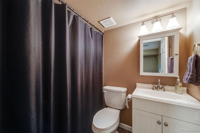 236 E Fair Ln, Centennial, CO 80121 - bathroom with vanity, toilet, and a textured wall