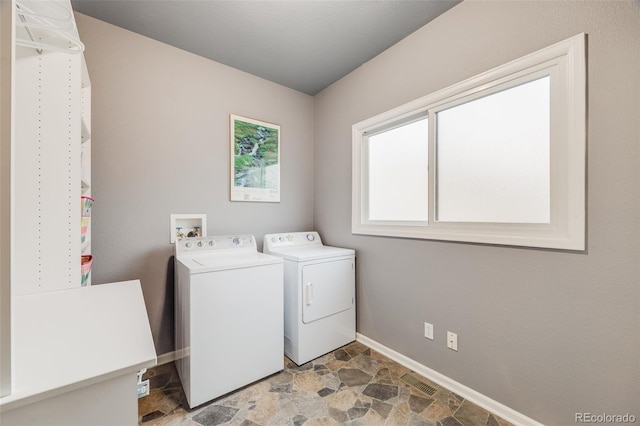 236 E Fair Ln, Centennial, CO 80121 - laundry room featuring stone finish floors, washing machine and clothes dryer, and baseboards