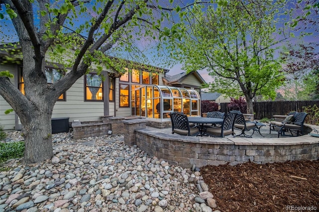 236 E Fair Ln, Centennial, CO 80121 - back of property with a sunroom, a fenced backyard, and a patio area