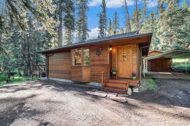 28192 Shadow Mountain Dr, Conifer, CO 80433 - view of front of house featuring dirt driveway and a carport