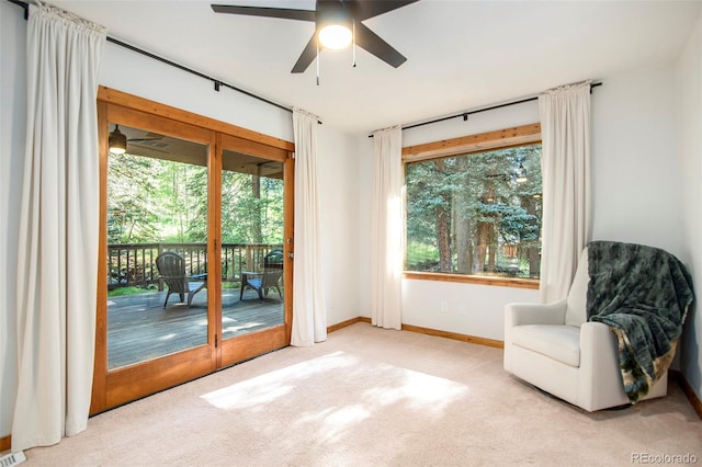 living area featuring ceiling fan and light colored carpet