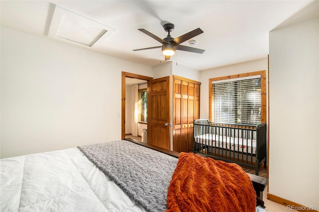 bedroom featuring multiple windows, carpet flooring, ceiling fan, and a closet