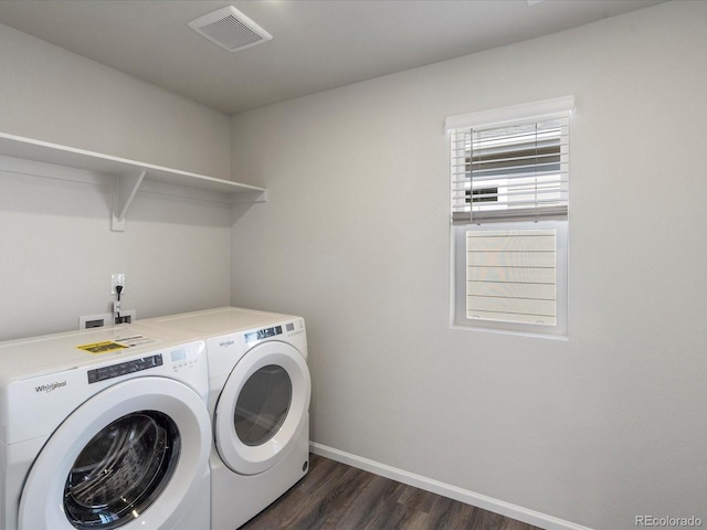 laundry room featuring visible vents, dark wood finished floors, baseboards, laundry area, and washing machine and clothes dryer