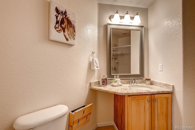 20341 E 48th Pl, Denver, CO 80249 - bathroom featuring a shower, toilet, a textured wall, and vanity