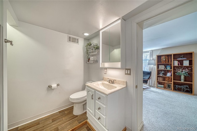 224 W Warren Ave, Cripple Creek, CO 80813 - bathroom featuring vanity, toilet, baseboards, and wood finished floors