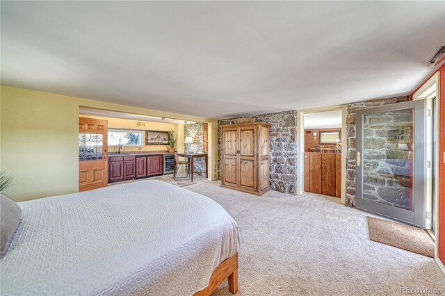 224 W Warren Ave, Cripple Creek, CO 80813 - bedroom with a sink, access to exterior, and light colored carpet