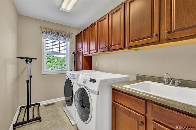 8489 S Quay St, Littleton, CO 80128 - laundry area featuring cabinet space, washing machine and dryer, and light tile patterned floors