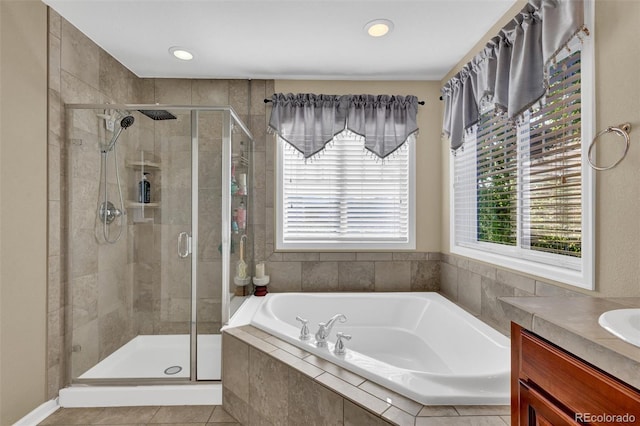 8489 S Quay St, Littleton, CO 80128 - bathroom featuring plenty of natural light, a garden tub, a shower stall, vanity, and recessed lighting