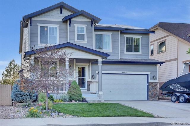 8489 S Quay St, Littleton, CO 80128 - craftsman-style house with a garage, a porch, concrete driveway, and a front yard