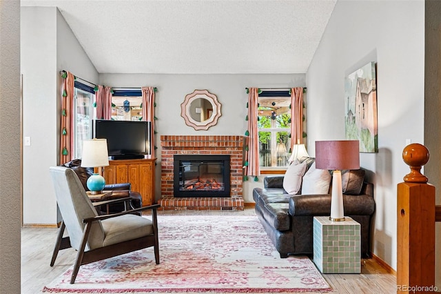 13313 Cherry Cir, Thornton, CO 80241 - living room featuring vaulted ceiling, wood finished floors, a fireplace, a textured ceiling, and baseboards