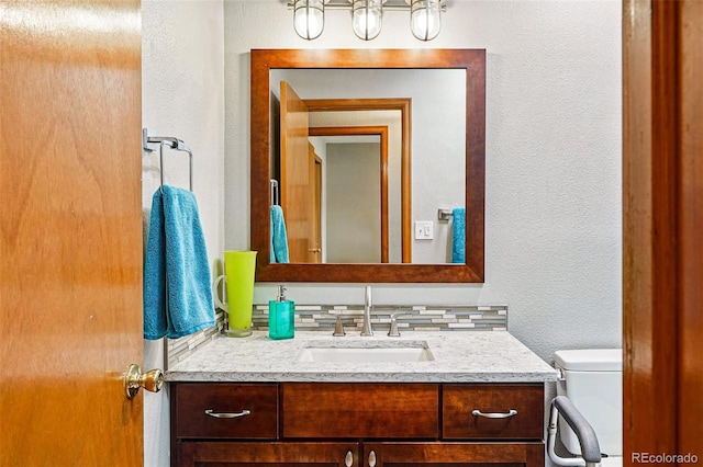 13313 Cherry Cir, Thornton, CO 80241 - half bath with vanity, a textured wall, toilet, and a chandelier