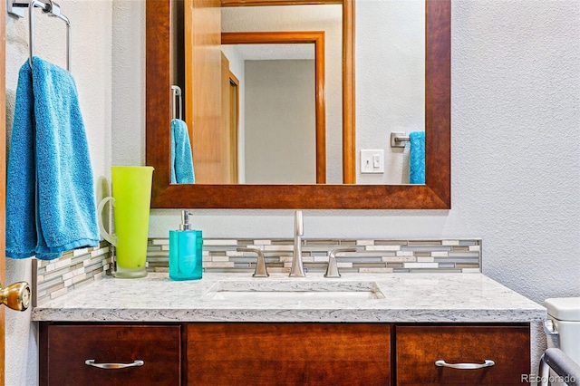 13313 Cherry Cir, Thornton, CO 80241 - bathroom featuring vanity, a textured wall, and toilet