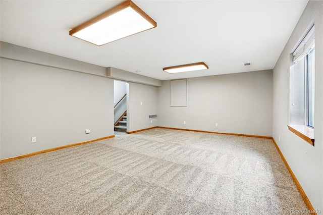 13313 Cherry Cir, Thornton, CO 80241 - below grade area featuring light carpet, stairs, and baseboards