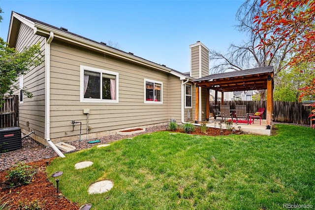 13313 Cherry Cir, Thornton, CO 80241 - rear view of house with a patio area, a chimney, and central AC unit