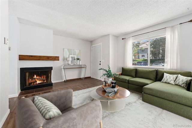 6011 Yarrow St Unit I, Arvada, CO 80004 - living area with wood finished floors, a fireplace, and a textured ceiling