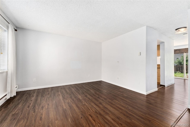 6011 Yarrow St Unit I, Arvada, CO 80004 - spare room featuring dark wood-style flooring and a textured ceiling