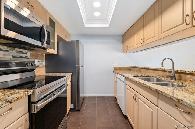 6011 Yarrow St Unit I, Arvada, CO 80004 - kitchen with appliances with stainless steel finishes, a tray ceiling, light stone counters, recessed lighting, and dark tile patterned floors
