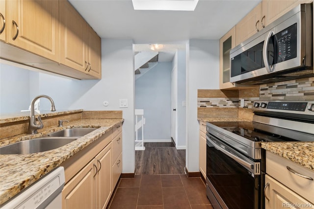 6011 Yarrow St Unit I, Arvada, CO 80004 - kitchen with stainless steel appliances, decorative backsplash, dark tile patterned flooring, light stone counters, and glass insert cabinets