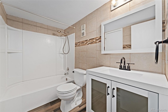 6011 Yarrow St Unit I, Arvada, CO 80004 - bathroom with tile walls, backsplash, shower / bath combination, vanity, and wood finished floors