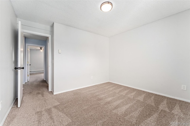 6011 Yarrow St Unit I, Arvada, CO 80004 - spare room featuring light colored carpet, a baseboard radiator, and a textured ceiling