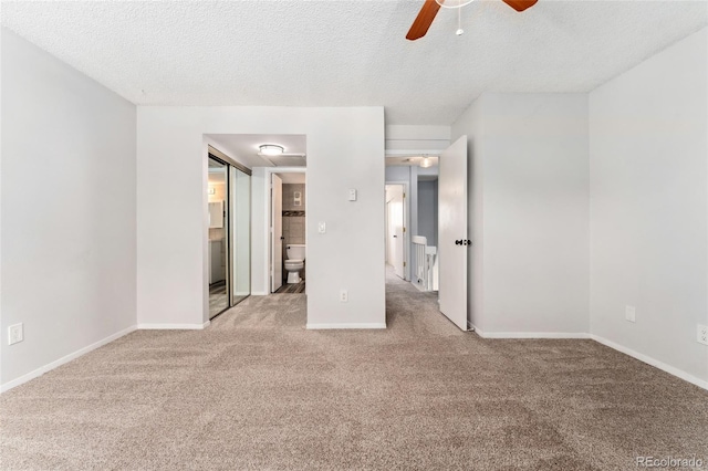 6011 Yarrow St Unit I, Arvada, CO 80004 - unfurnished bedroom with carpet, a textured ceiling, connected bathroom, and ceiling fan