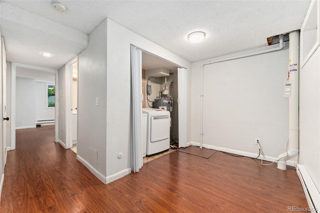6011 Yarrow St Unit I, Arvada, CO 80004 - hallway featuring a baseboard heating unit, baseboard heating, washer / clothes dryer, wood finished floors, and a textured ceiling