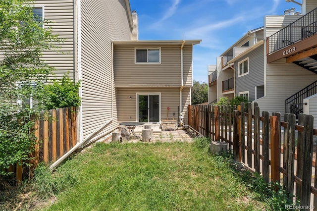 6011 Yarrow St Unit I, Arvada, CO 80004 - rear view of property featuring a patio and a fenced backyard