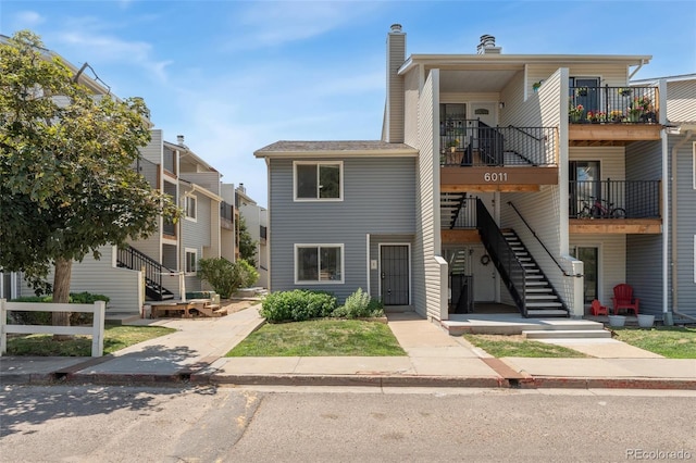 6011 Yarrow St Unit I, Arvada, CO 80004 - view of property with stairway and a chimney