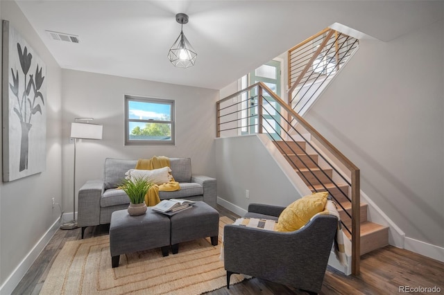living room with baseboards and wood finished floors