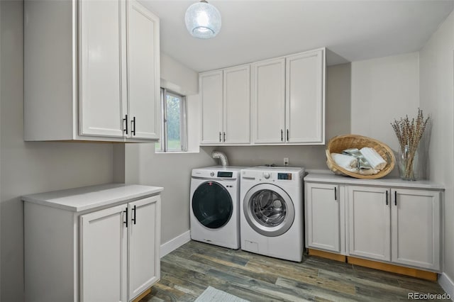 washroom with cabinet space, washer and clothes dryer, dark wood finished floors, and baseboards