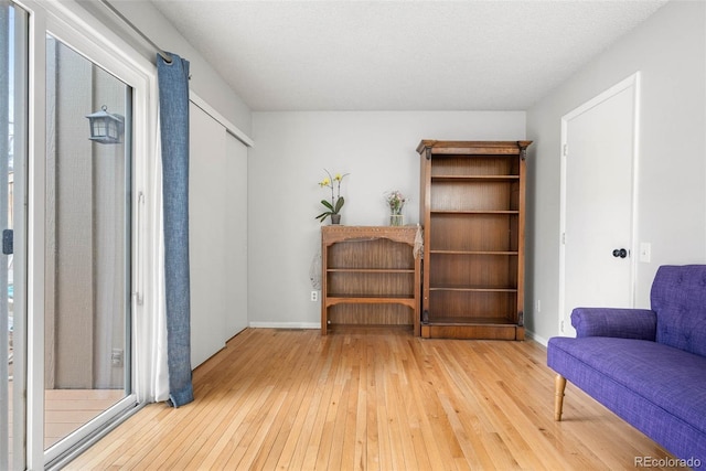 sitting room with hardwood / wood-style flooring