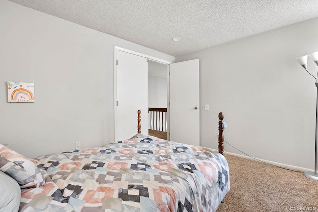 bedroom with carpet flooring and a textured ceiling