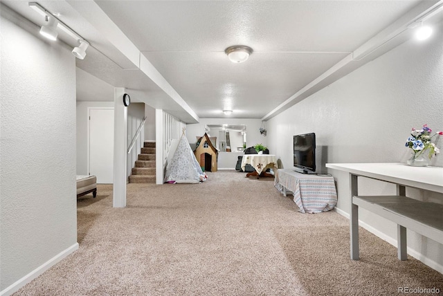 interior space with carpet and track lighting