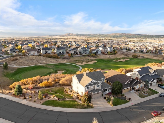 drone / aerial view with golf course view and a residential view