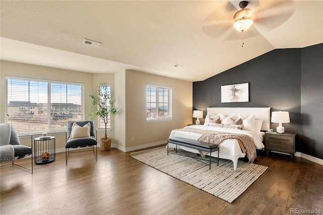 bedroom featuring dark wood-style floors, visible vents, multiple windows, and vaulted ceiling