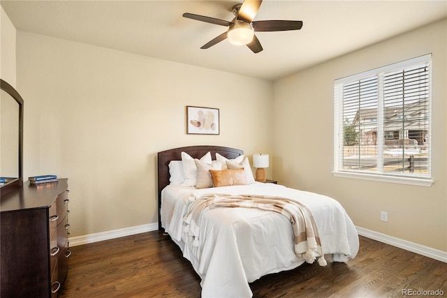 bedroom with a ceiling fan, baseboards, and dark wood-style flooring