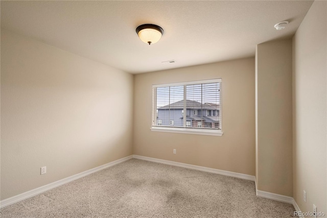 spare room featuring visible vents and baseboards