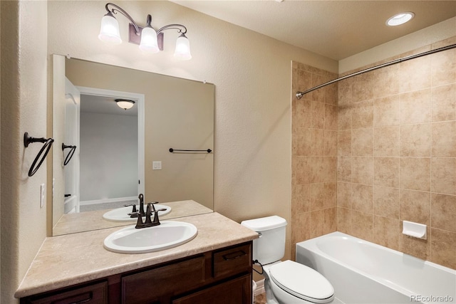 bathroom featuring vanity, shower / bathing tub combination, and toilet