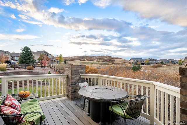 deck featuring a residential view and outdoor dining space