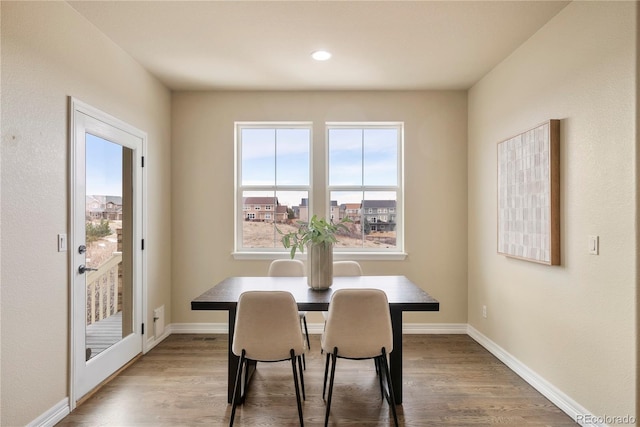 dining room featuring baseboards and wood finished floors