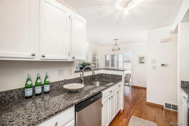 kitchen with a sink, dishwasher, wood finished floors, and white cabinets