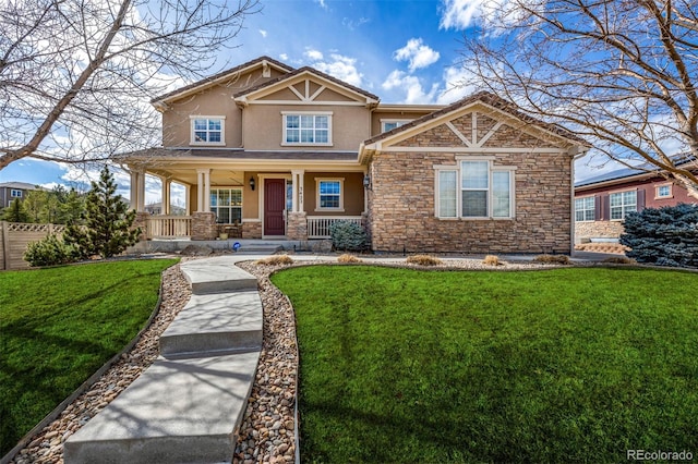 craftsman house with stone siding, a front lawn, and stucco siding