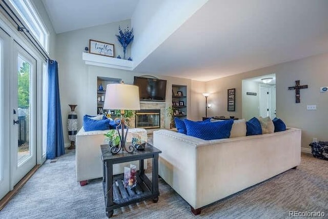 7176 S Pierson St, Littleton, CO 80127 - living area featuring a glass covered fireplace and vaulted ceiling
