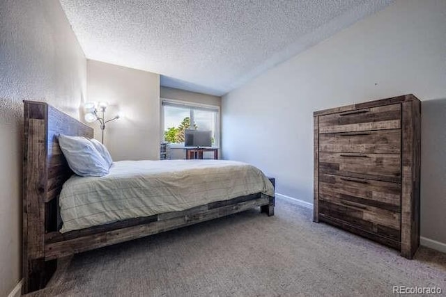 7176 S Pierson St, Littleton, CO 80127 - carpeted bedroom with a textured ceiling, vaulted ceiling, and baseboards