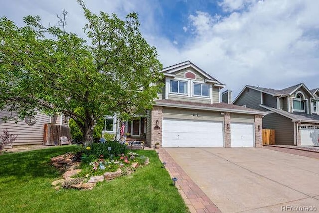 7176 S Pierson St, Littleton, CO 80127 - view of front of house with concrete driveway, brick siding, and an attached garage