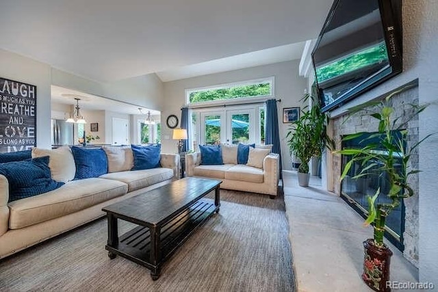7176 S Pierson St, Littleton, CO 80127 - living area with a chandelier, a fireplace, concrete floors, and french doors