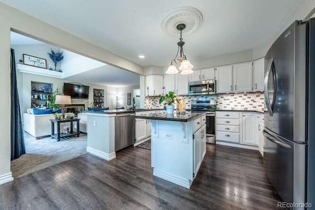 7176 S Pierson St, Littleton, CO 80127 - kitchen with stainless steel appliances, open floor plan, white cabinetry, and dark countertops