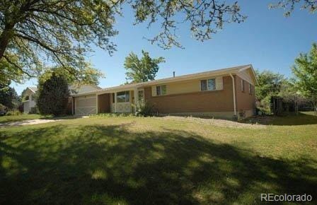 single story home with a garage and a front lawn